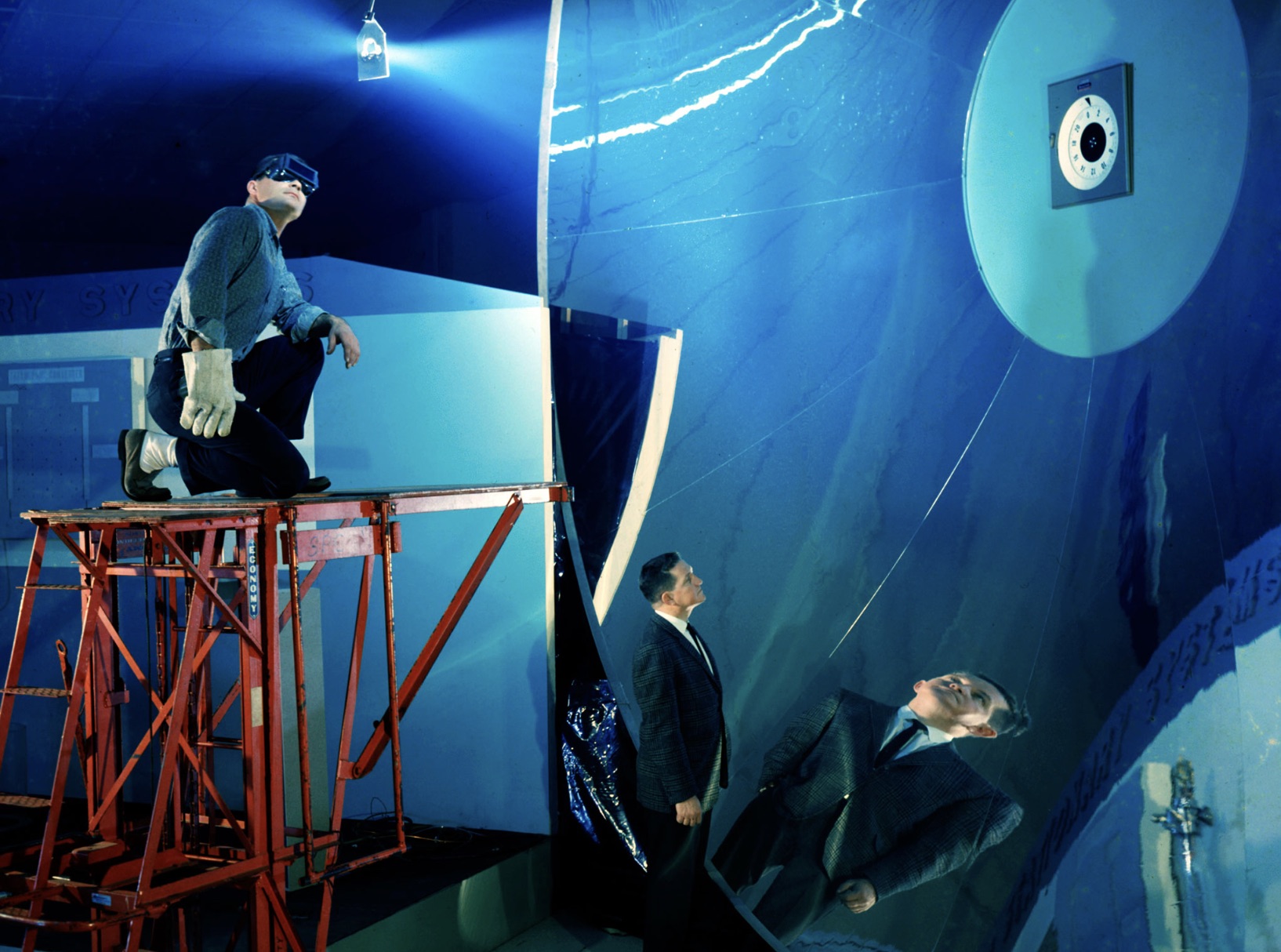 Workers inspecting a Solar Collector Mirror 